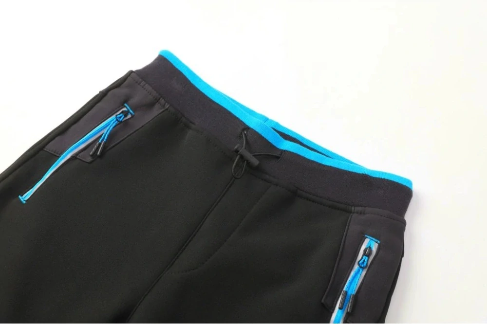 Chlapecké softshellové kalhoty zateplené Kugo HK5612, černé / tyrkysový zip